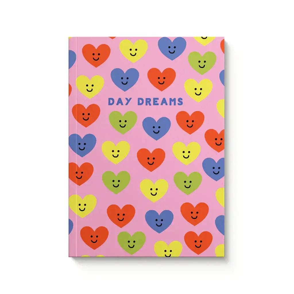 Notebook with colorful heart designs and 'Day Dreams' text on a pink background